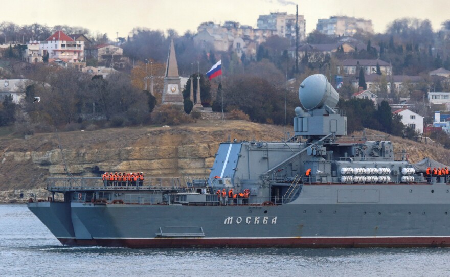 Russian navy officers line up on the deck as the guided missile cruiser Moskva (Moscow) sailed into a harbor after tracking NATO warships in the Black Sea, in the port of Sevastopol, Crimea, Nov. 16, 2021. Russian authorities said the Moskva sank Thursday.