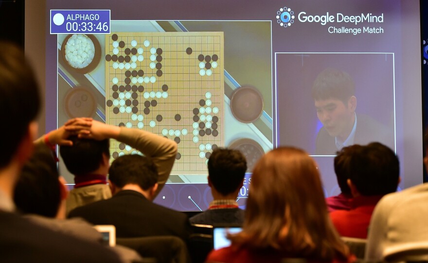Journalists watch a big screen showing live footage of the third game of the Google DeepMind Challenge Match between Lee Sedol, one of the greatest modern players of the ancient board game Go, and the Google-developed supercomputer AlphaGo at a hotel in Seoul on Saturday. AlphaGo won, clinching its victory in the best-of-5 match.