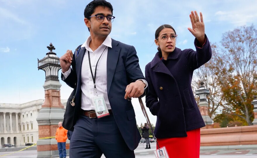U.S. Rep. Alexandria Ocasio-Cortez, right, and her then-chief of staff Saikat Chakrabarti, left, walk together after a group photo of the freshman class of Congress on Capitol Hill in Washington, D.C., on Nov. 14, 2018.
