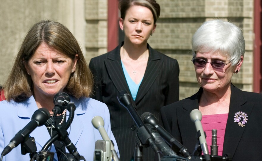 Rhode Island Education Commissioner Deborah Gist, (center) looks on as Central Falls School Superintendent Frances Gallo (right) and Central Falls Teachers' Union President Jane Sessums (left) talk to the media just after the union approved an agreement allowing the entire staff to be rehired last May.