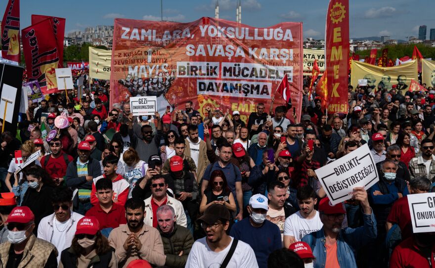 Demonstrators hold flags, banners and shout slogans during the annual May Day demonstration in the Maltepe district of Istanbul on Sunday.