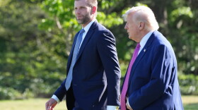 President Donald Trump walks with Eric Trump as they prepare to depart on Marine One from the South Lawn of the White House, Friday, April 10, 2026, in Washington.