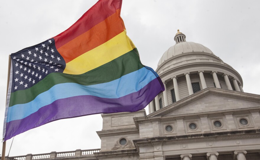 A pride-themed rainbow flag flies over the steps of the Arkansas State Capitol in Little Rock. Until recently, the Arkansas House was considering a bill to restrict where drag shows can be performed.