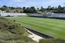 A landscaper trims the grassy field in a lawn mower at University of San Diego's Torero Stadium, March 16, 2026.