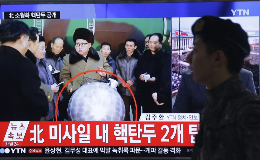 A South Korean army soldier walks by a TV screen in March showing North Korean leader Kim Jong Un with superimposed letters that read: "North Korea's nuclear warhead."