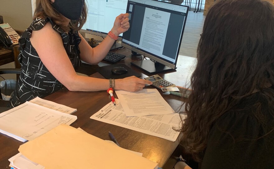 Stephanie Graves helps a tenant apply for rental assistance at the main office of one of her properties in Houston.