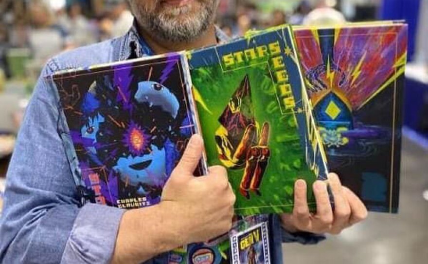 Artist and graphic novelist Charles Glaubitz is shown in an undated photo, holding his volumes of "Starseeds."