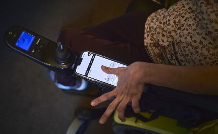 Ellingen, who has athetoid cerebral palsy, uses an app on her phone that takes her typed text and speaks her words aloud.