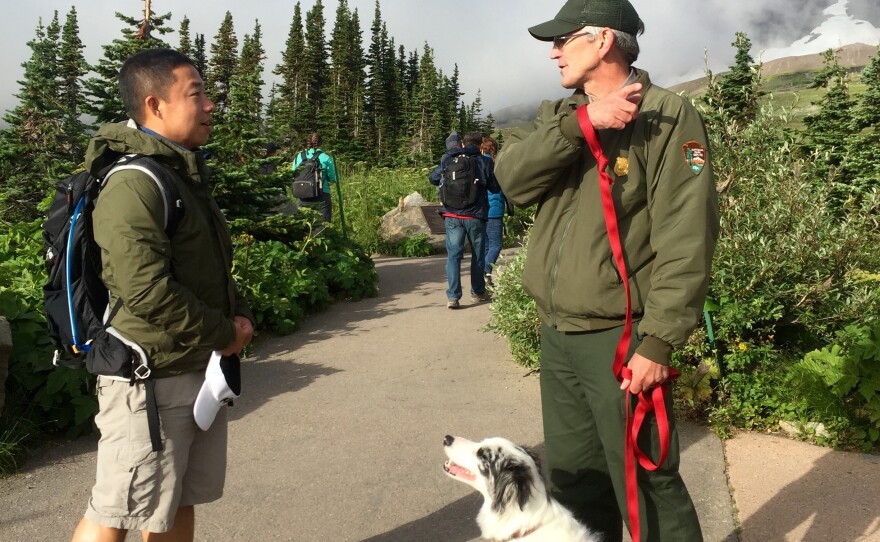Part of Gracie and Ranger Mark Biel's (right) job is teaching park visitors how to safely view wildlife along popular trails, like the Hidden Lake Overlook trail from Logan Pass.