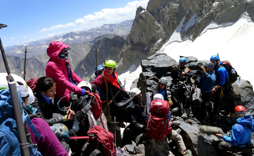 The girls who made the "Lion Daughters" summit take a rest at the top as a video crew from HBO/Vice films them.