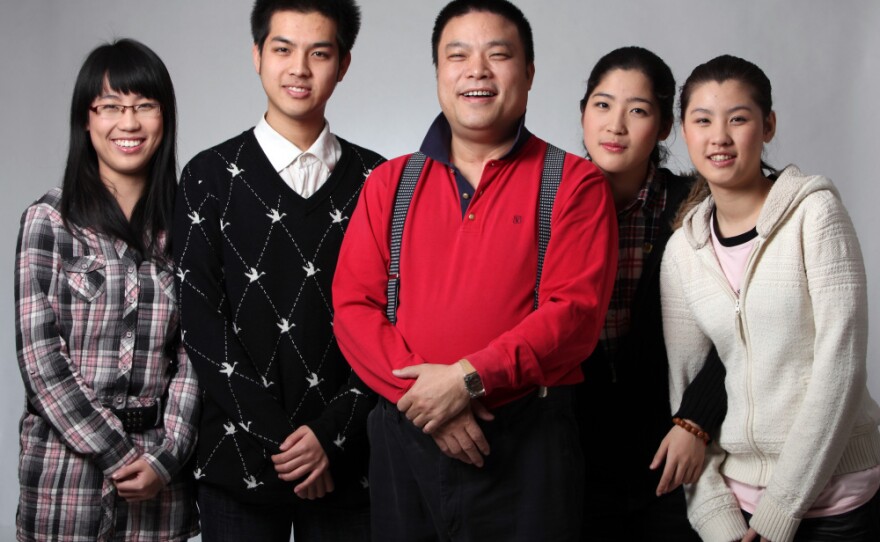 Wolf Dad Xiao Baiyou is shown in this publicity image with his four children, three of whom go to Peking University. He believes this is due to his method of beating his kids. The youngest is 16 and is hoping to study music at China's Central Conservatory of Music.