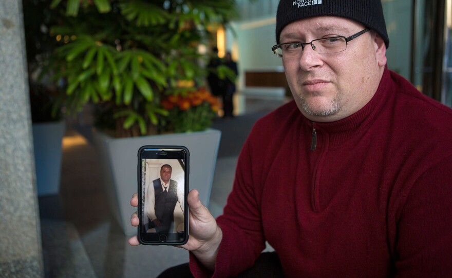 Anthony Salemi, of Everett, Mass., holds a photo of his brother Joe, who died from an overdose of fentanyl-laced heroin earlier this year.