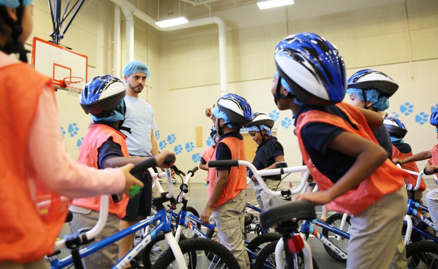 Gesualdi has set up a course in the gym — with stop and yield signs and arrows to mark the turns.