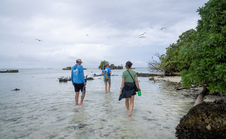 Alex Wegmann, Dana Sabine and Katie Franklin of The Nature Conservancy head to a seabird colony.