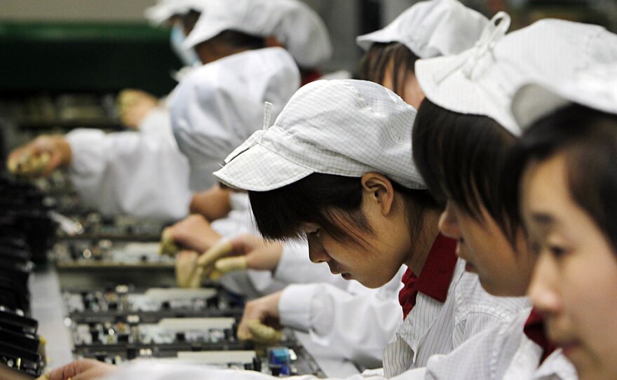 Employees work on the production line at the Foxconn complex in the southern Chinese city of Shenzhen. A string of suicides has plagued the electronics company's main facility in China.