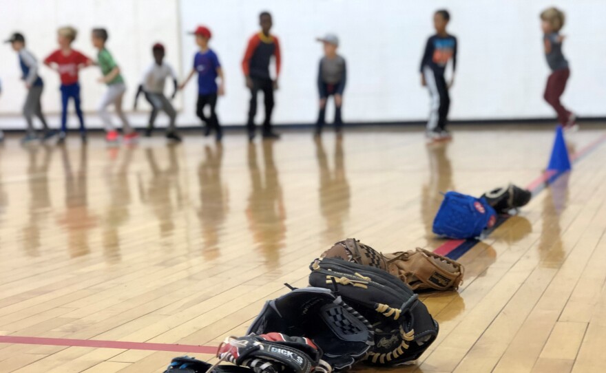 Kids do calisthenics before starting a baseball clinic in Washington, D.C.