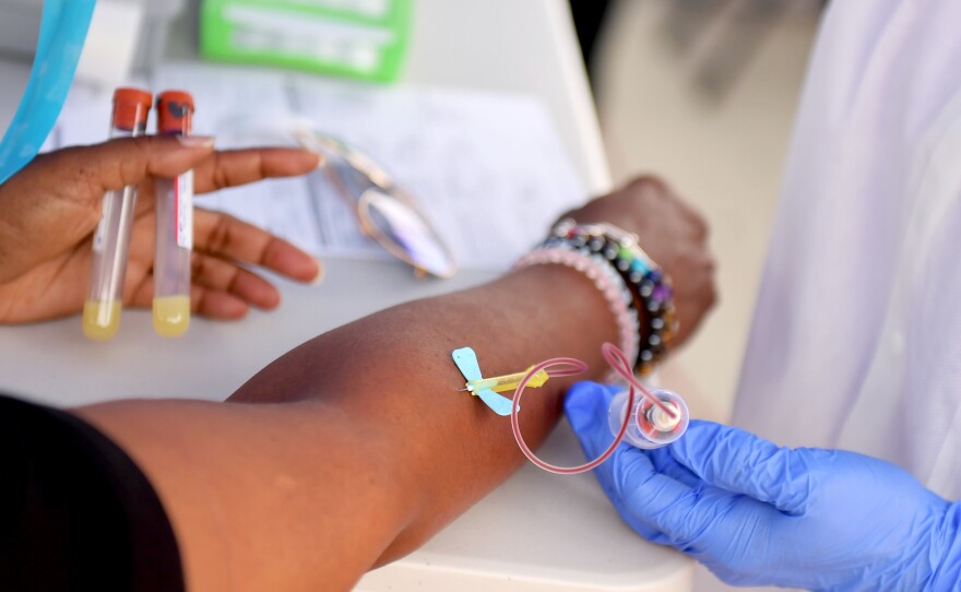 A medical worker draws blood at a free coronavirus antibody testing event in Los Angeles on Wednesday.