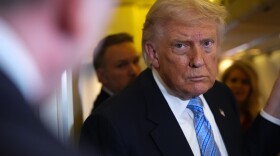 President Donald Trump speaks to reporters aboard Air Force One, Friday, May 15, 2026, as he returns from a trip to Beijing, China.