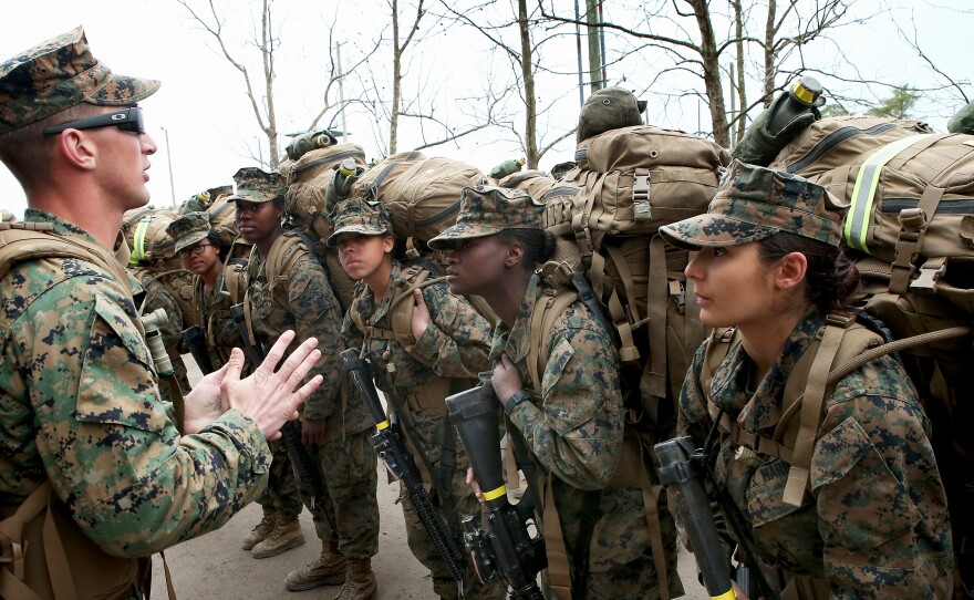 Sgt. Jarrod Simmons speaks to his squad of Marines before they head out on a training march with 55-pound packs on Feb. 22, 2013 at Camp Lejeune, N.C.