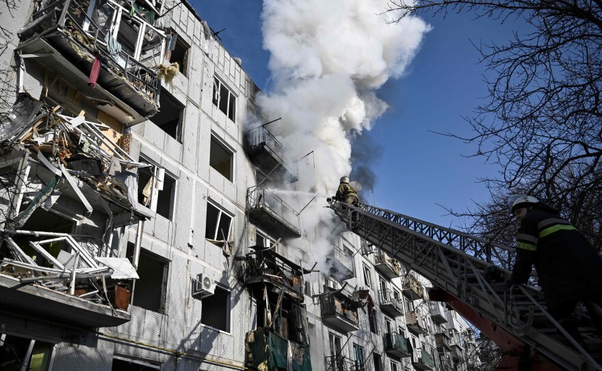 Firefighters respond to a fire in a building after Russian forces bombed the eastern Ukrainian town of Chuguiv on Feb. 24.