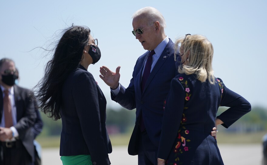 President Biden speaks with Rep. Rashida Tlaib, D-Mich., left, and Rep. Debbie Dingell, D-Mich., as he arrives at in Detroit Tuesday.