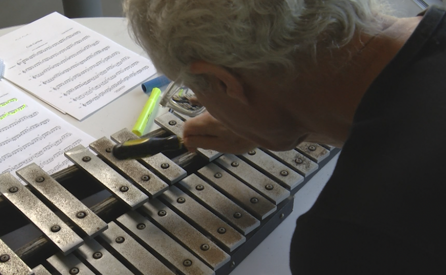 Composer, Joseph Martin Waters, plays his composition on a glockenspiel.