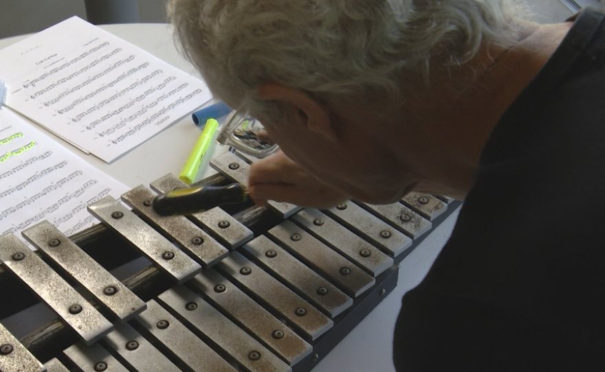 Composer, Joseph Martin Waters, plays his composition on a glockenspiel. 