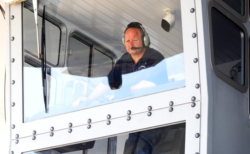 Bill Couch looks down from the cab of the crawler. Couch is one of only six people certified to drive the enormous machine.
