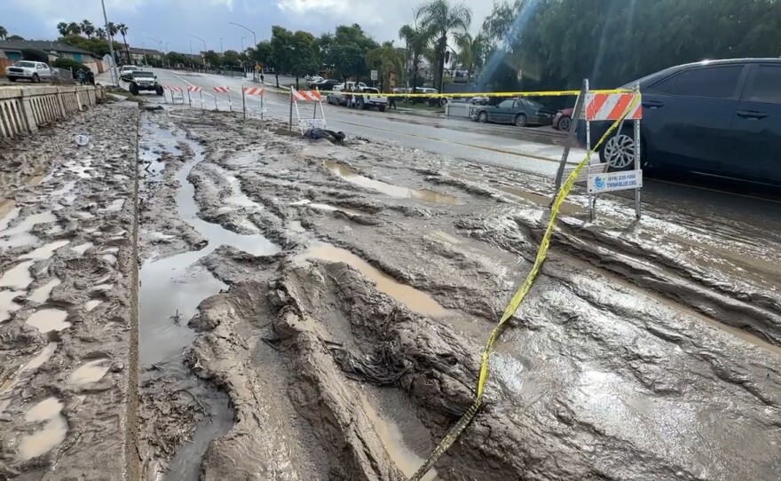 Cars drive by mud and pools of water following Monday's storm. San Diego, Calif. Jan. 23, 2024.