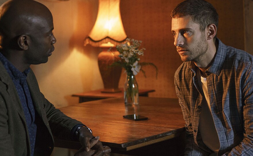 Shown from left to right: David Gyasi as Steve Julian Morris as Adam Berryman.