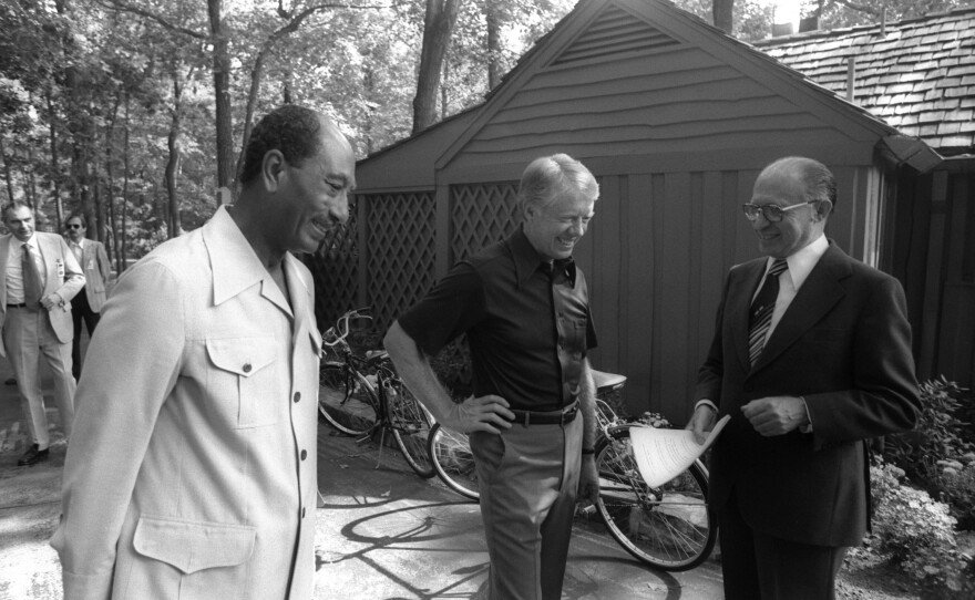 In this handout file photo, Israeli Prime Minister Menachem Begin chats informally with Egyptian President Anwar el-Sadat and President Carter during their peace talks on Sept. 6, 1978, at Camp David in Maryland.