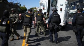 Drug Enforcement Administration (DEA) agents alongside other law enforcement officers work the scene near MacArthur Park after federal authorities made arrests on charges related to selling illicit drugs on Wednesday, May 6, 2026, in Los Angeles.