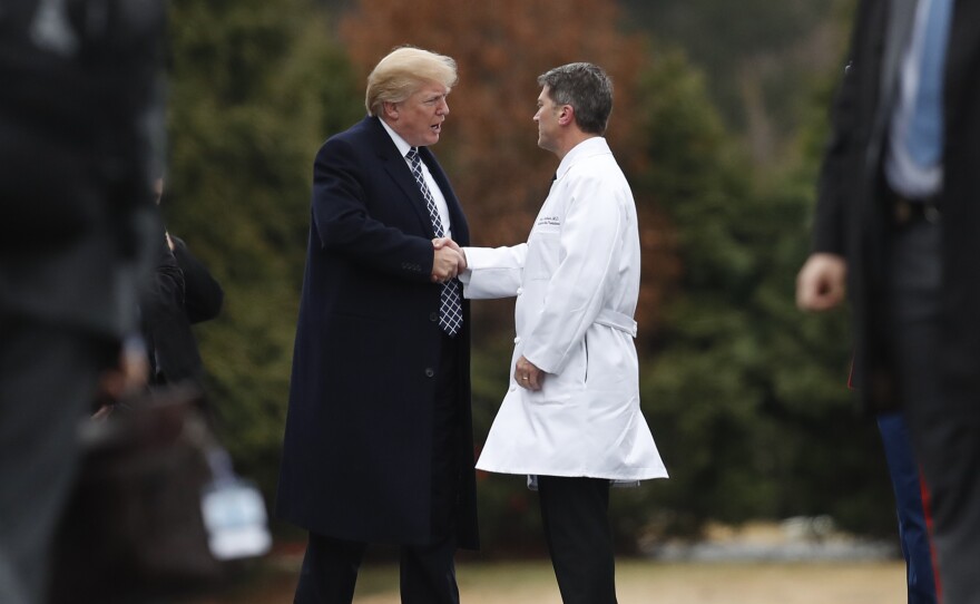 President Trump shakes hands with now-former White House physician Dr. Ronny Jackson in January 2018, following his first medical checkup as president.