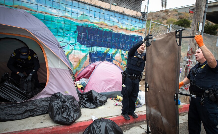 San Diego police impound the belongings of a person who was detained by police for having an outstanding warrant, San Diego, June 9, 2022.