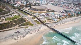 Students are shown standing on the Border Field State Park and Playas de Tijuana to form the words "Unite Por El Mar," Feb. 26, 2015. 