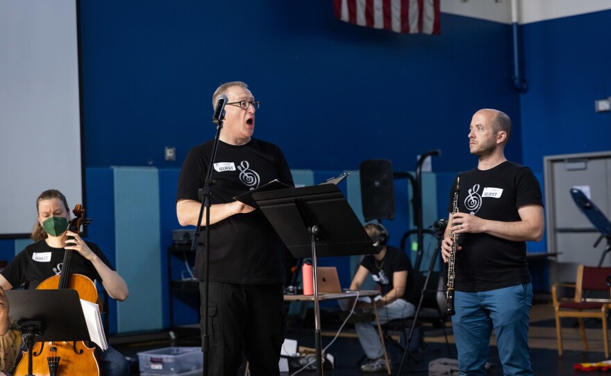 Vocalist Scott Graff and oboist Aaron Hill performing with a Street Symphony ensemble.