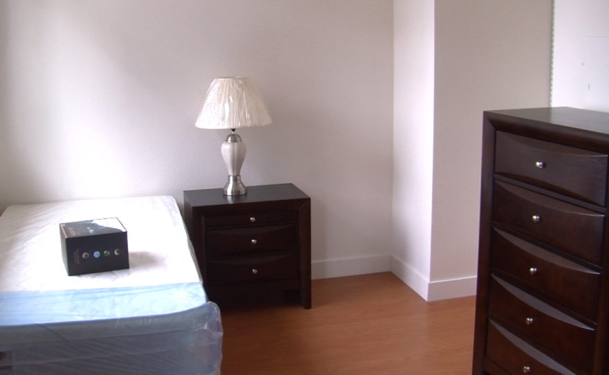 Each Hotel Churchill unit has a bedroom area, with a bed, dresser and table, Sept. 19, 2016.