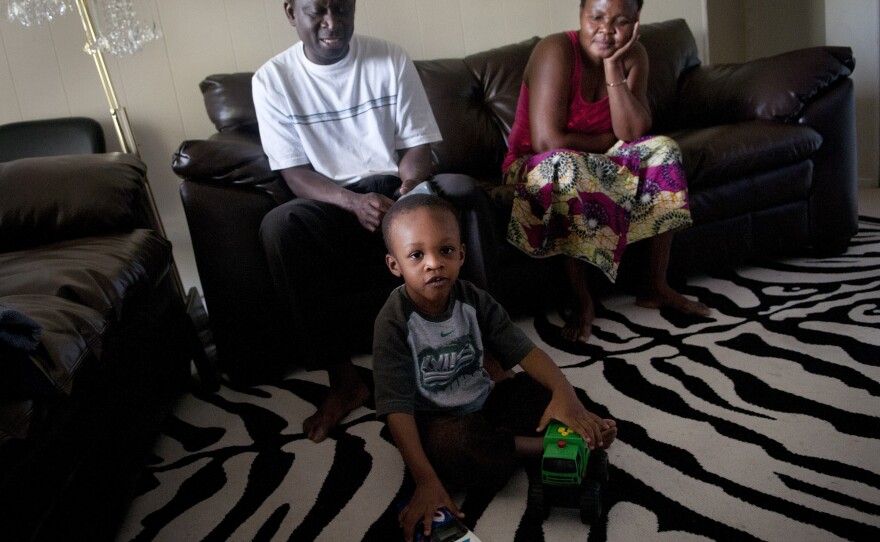 Fafaneva Phillip Avudufu (left) and his wife, Akouavi Davi, with their grandson Joshua, 4, in their apartment in Gaithersburg, Md.