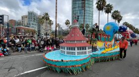A float with a miniature of the Hotel Del Coronado and other San Diego landmarks in the Holiday Bowl Parade, Dec. 28, 2022.