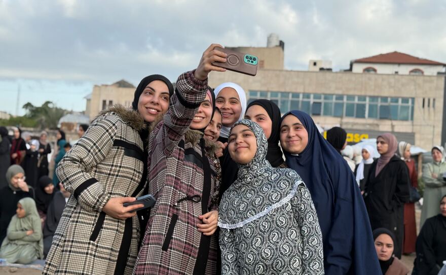 Young women pose for selfies in Gaza City on Friday.