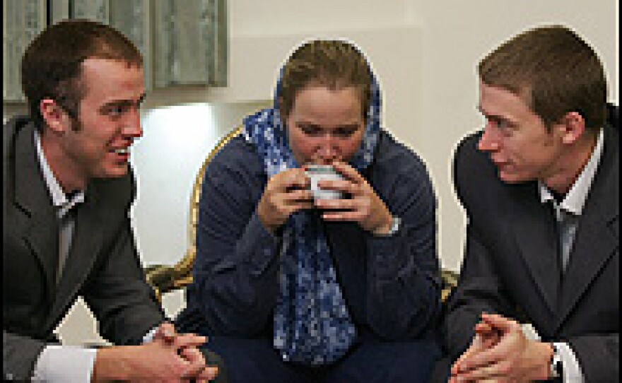Freed British servicewoman Turney drinks coffee as she waits with fellow sailors at Mehrabad airport before leaving Iran.