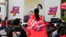 An image of former South Korean President Yoon Suk Yeol and his wife Kim Keon Hee is seen during a rally by supporters outside of the Seoul High Court in Seoul, South Korea, Tuesday, April 28, 2026. The letters read "Not Guilty."