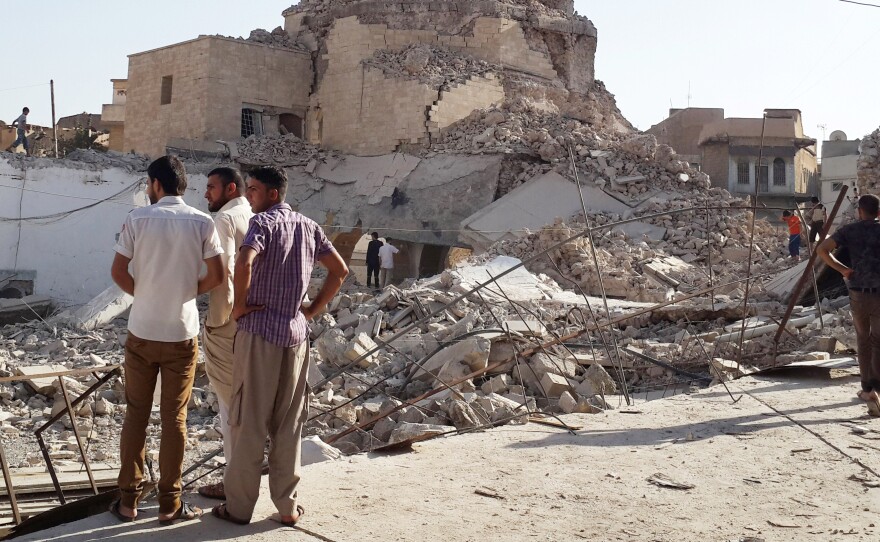 People inspect the remains of a destroyed mosque in Mosul on July 27.