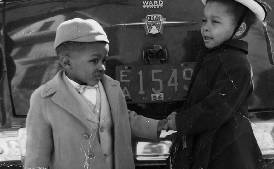 Two young children by car. Gretchen Sorin personal collection. (undated photo)