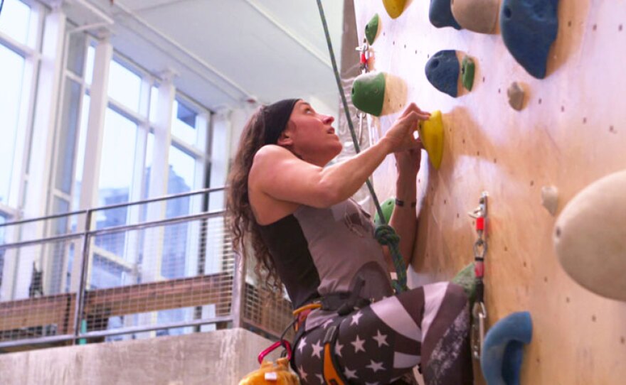 Retired Sgt. 1st Class Elana Duffy who suffered a traumatic brain injury in Iraq scales a rock climbing wall in Queens, N.Y.