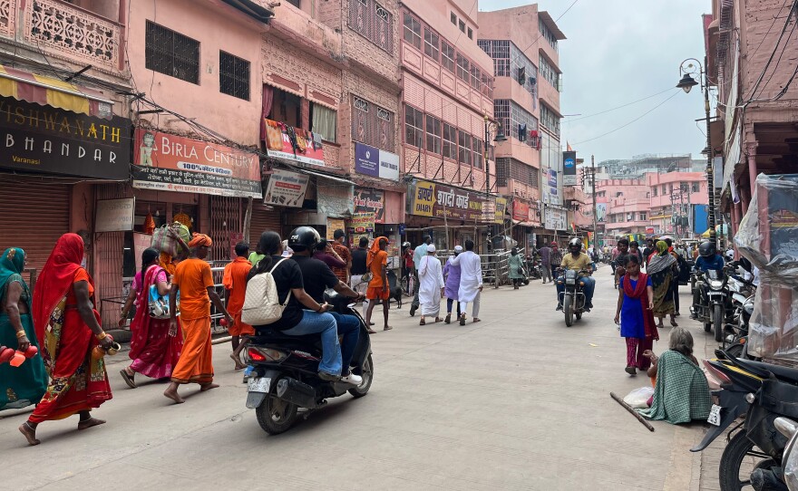 In Varanasi, Muslim men in skull caps and Hindu pilgrims wearing saffron clothes make their way to a temple-mosque complex that's the subject of an ongoing dispute.