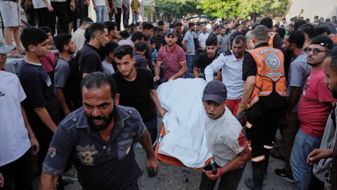 Palestinians carry a body from the site of an Israeli military strike in Gaza City, Sunday, Aug. 2, 2026.