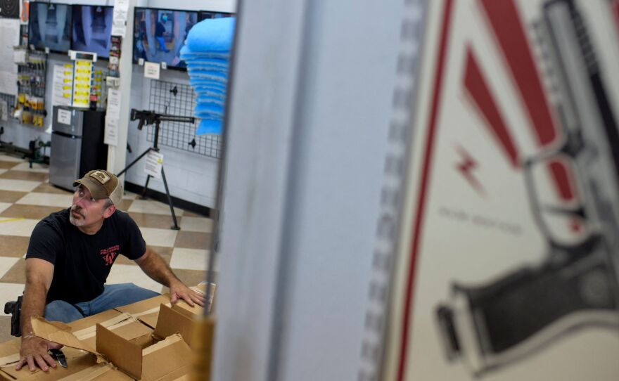 Employee Curt Hubbard unloads a shipment of ammunition at Full Armor Firearms in Houston, Texas on June 17, 2021.