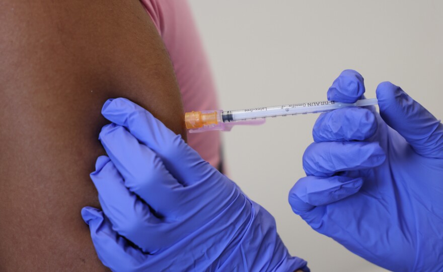 A doctor administers a dose of the monkeypox vaccine on Saturday in London.