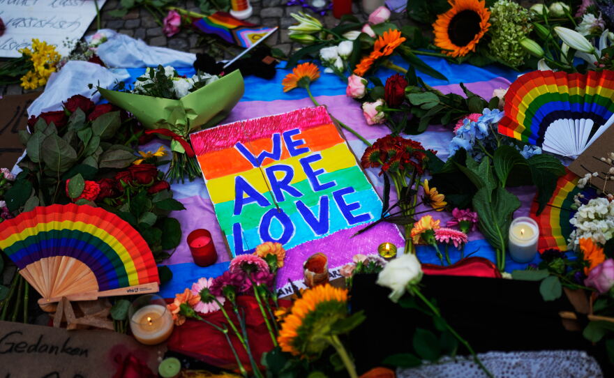 People leave flowers and notes outside the Brandenburg Gate in support of LGBTQ+ after a car rammed into a crowd at the Pride March in Berlin, Sunday, July 26, 2026.
